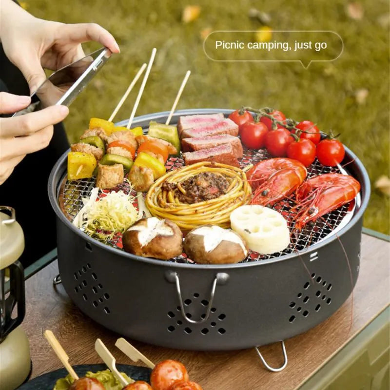 Portable stainless steel barbecue grill with detachable parts and storage bag for camping.