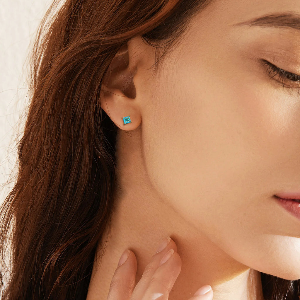 Gold-plated drop earrings with pear-shaped candy-coloured cubic zirconia stones on a simple setting.