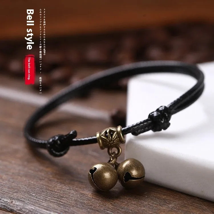 Adjustable nylon rope dog collar with brass bell shown in black, red, and coffee colours for small dogs.