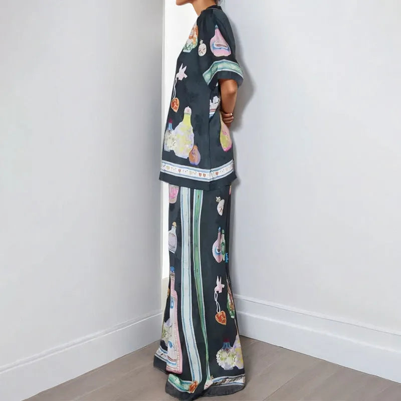 Black women's casual set with cartoon print, featuring a cardigan and trousers.