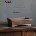 Rectangular purple sand bonsai pot with shallow basin, shown empty on a wooden surface.