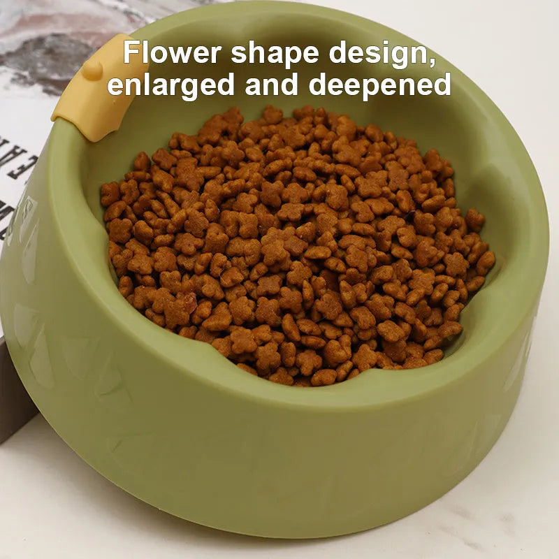Green plastic double pet bowl for cats and small dogs on a floor.