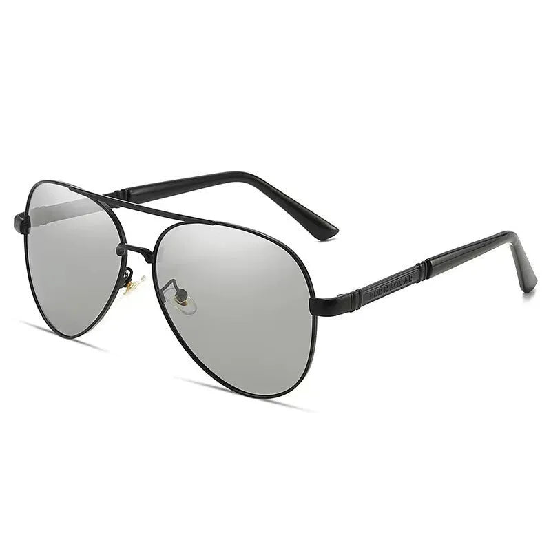 Gold frame men's polarised sunglasses with dragon-phoenix temple detail and grey lenses on a table.