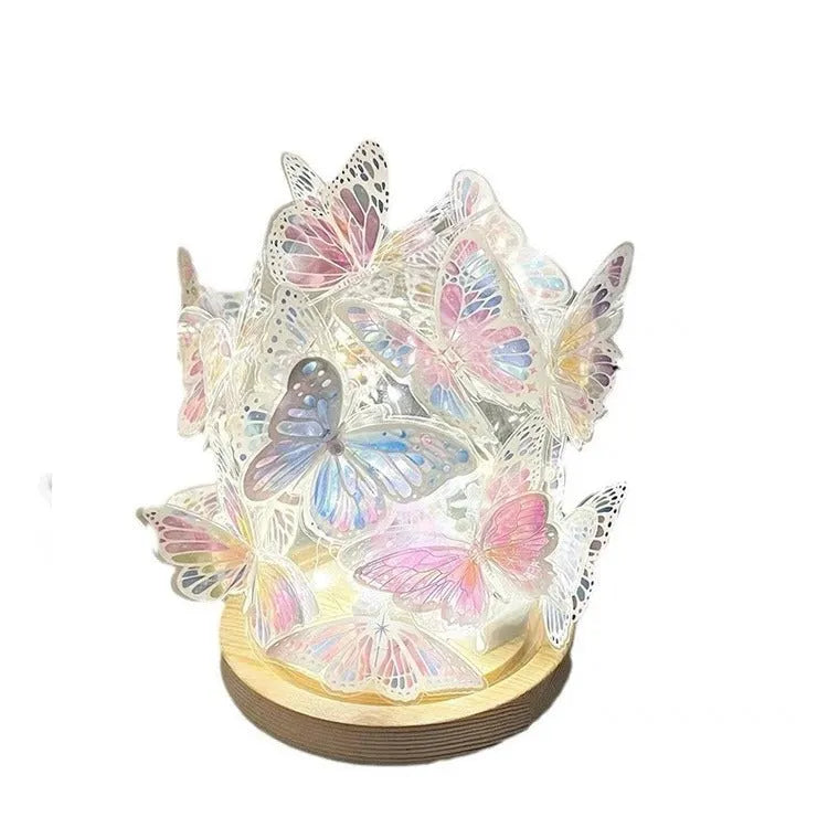 Handmade butterfly night light DIY kit with glass shade and raw wood base on a bedside table.