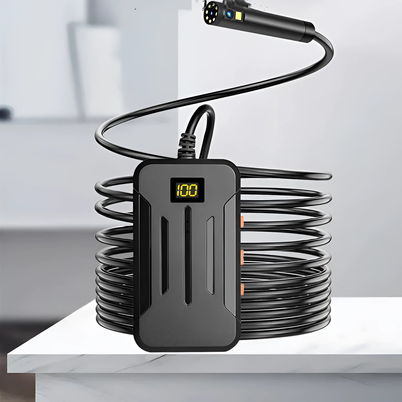 WiFi dual lens endoscope camera with 5.5mm and 8mm probes, magnet, and hook accessories on a table.