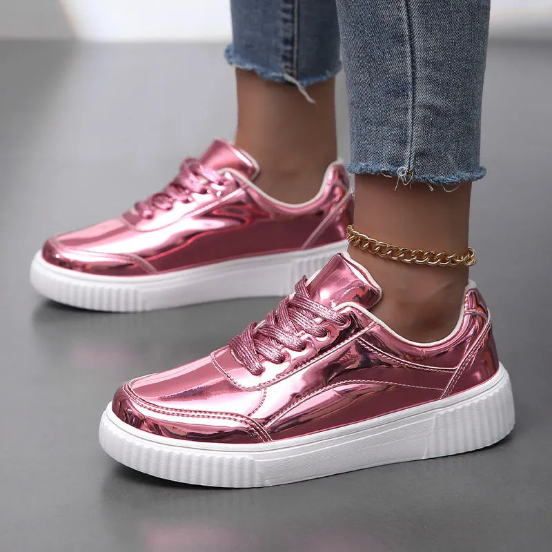 Gold sequinned platform sneakers with thick sole and round toe on a white background.