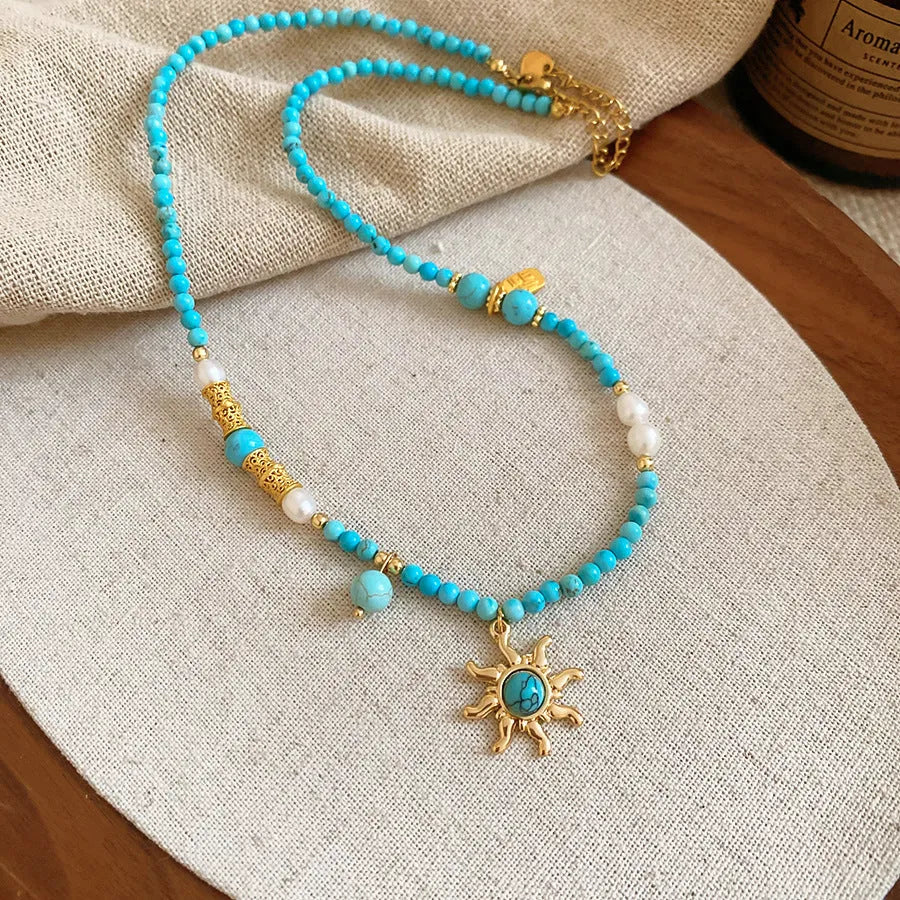 Freshwater pearl necklace with blue sun stone pendant on an adjustable clavicle chain.