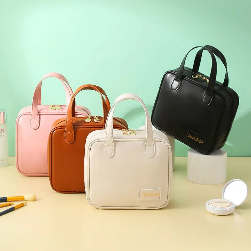 PU leather travel makeup bag in caramel mocha, 21x8x19cm, open to show compartments for cosmetics and toiletries