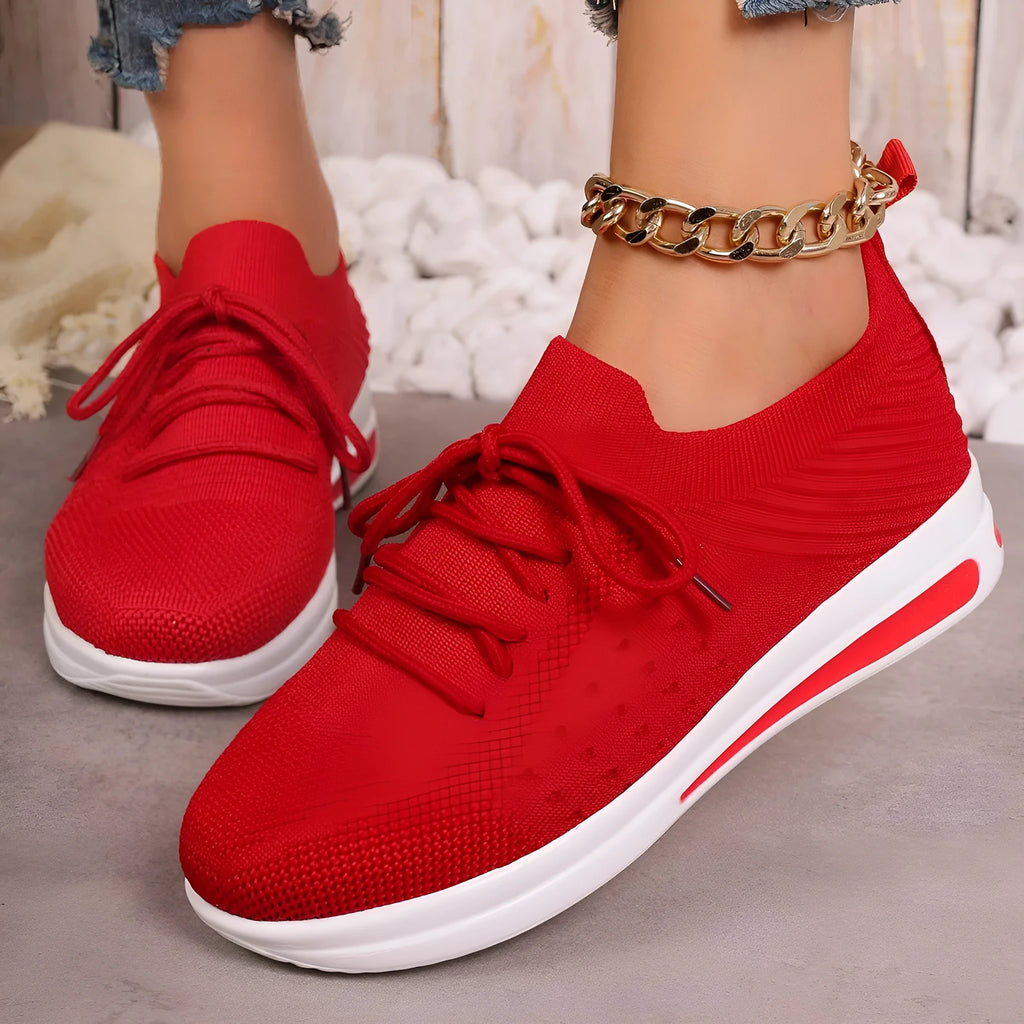 Women's low-top lace-up casual sneakers in red, black, and blue with a fly-knit pattern and round toe.