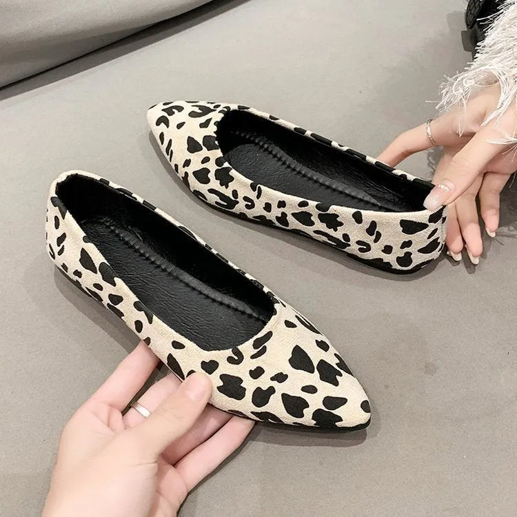 Women's leopard print flat pumps with a pointed toe, low heel, and cotton upper on a rubber sole.