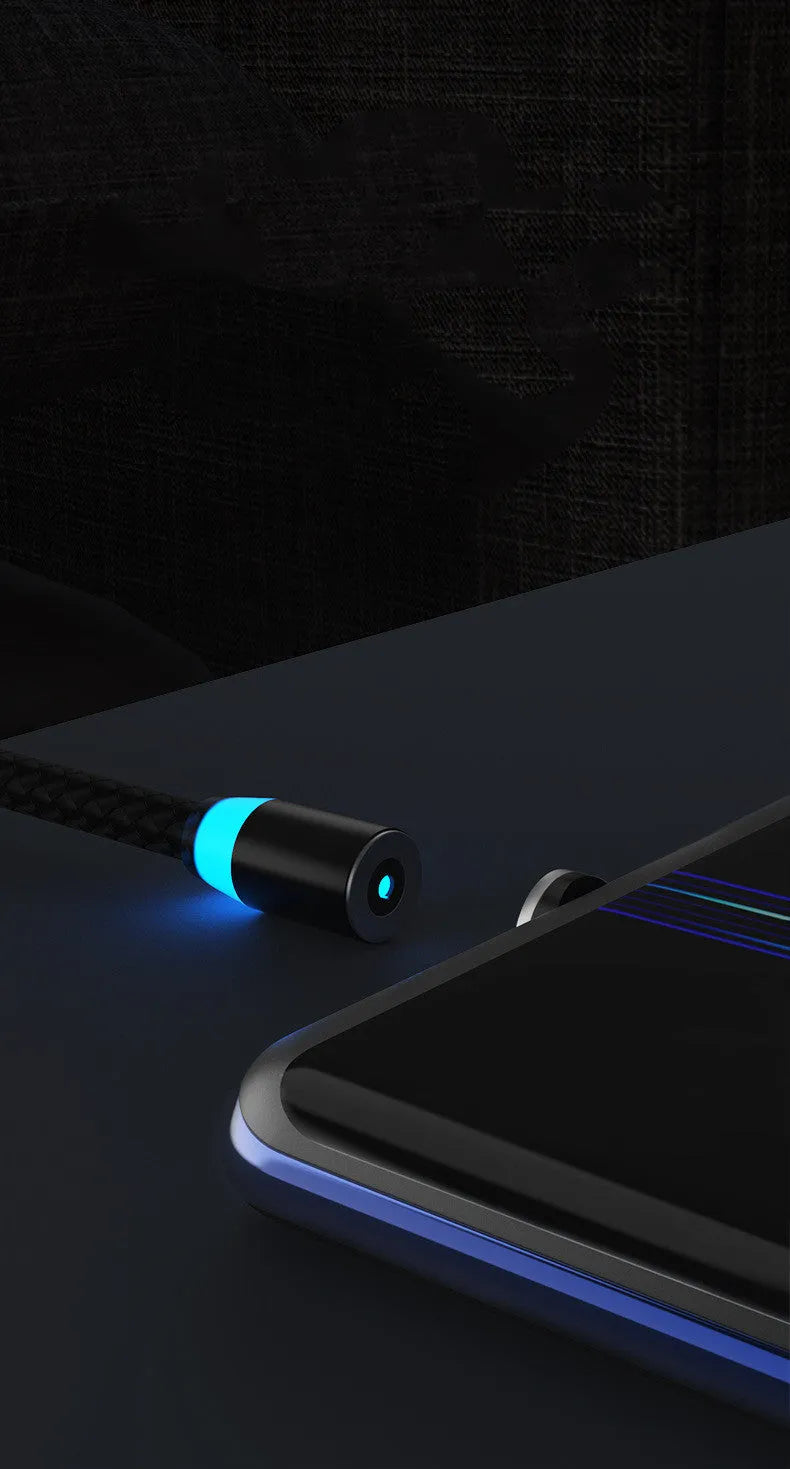 Magnetic charging cable with glowing LED light connected to a phone, showing black and silver colour options on a desk.