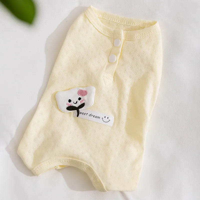 Soft yellow mesh pet shirt with cartoon cat patch and button closure on a small dog or cat
