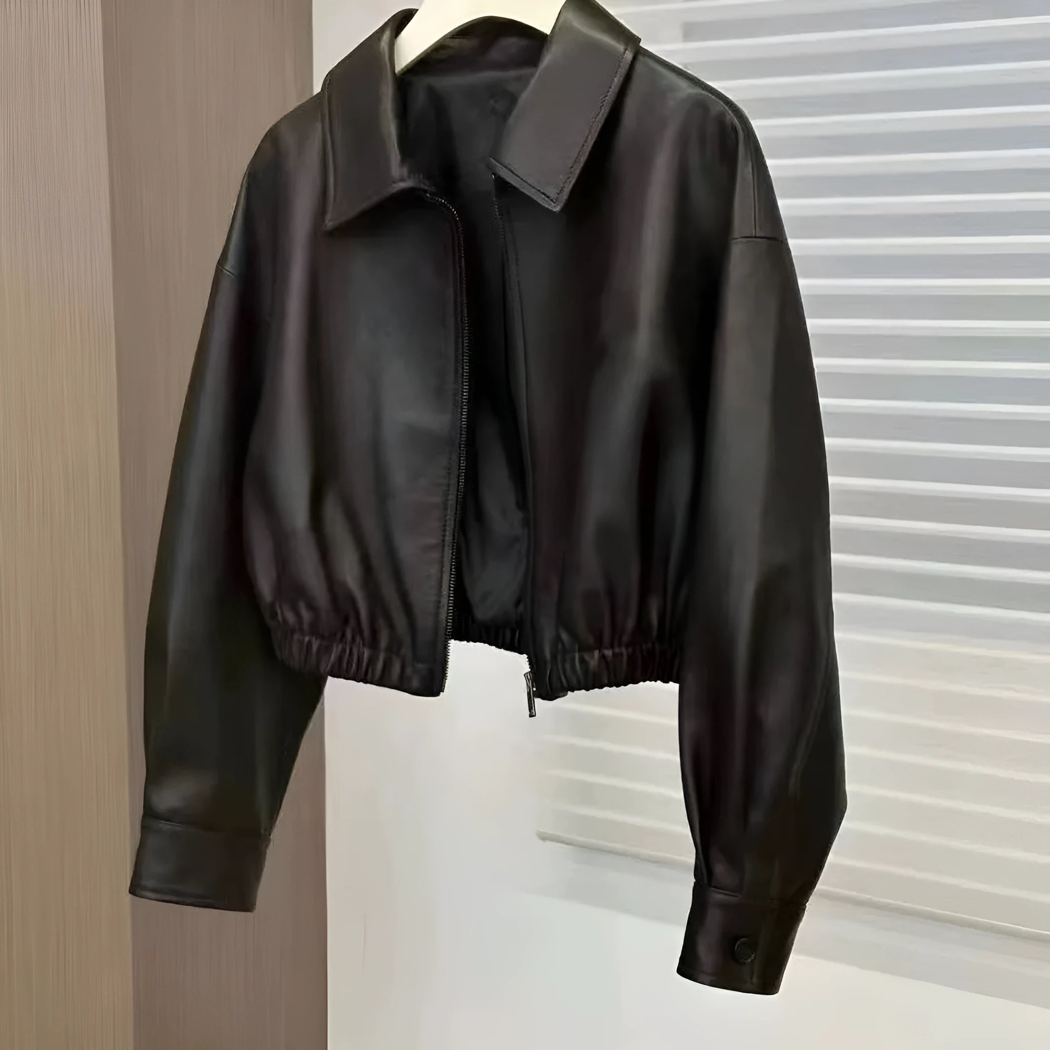 Women's black faux leather square-neck zip jacket with princess sleeves and washed finish on a model