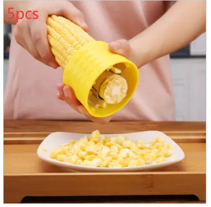 Yellow manual corn grinder thresher with corn-shaped design and stainless steel gear.