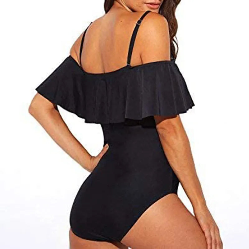 Black one-piece swimsuit with cut-out sides and ruffled shoulder straps