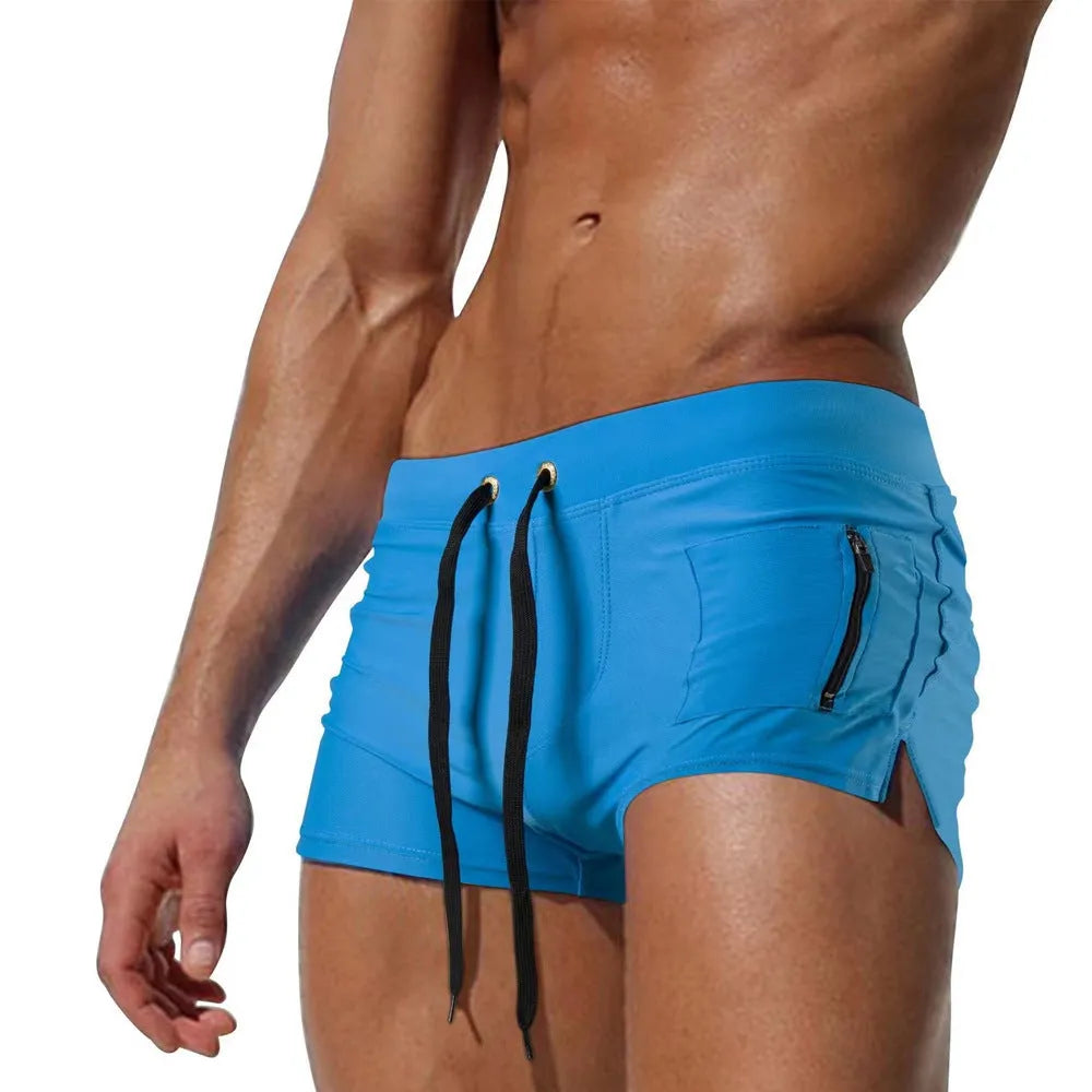 Men's black high-waist swimming trunks with front lace-up detail and spandex lining.