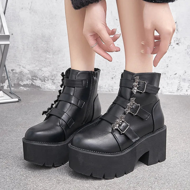 Black women's punk gothic ankle boots with a bat buckle and side zipper on a thick sole.