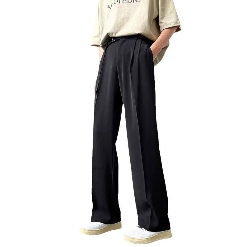 Model wearing thin black straight wide leg casual trousers with a loose fit.