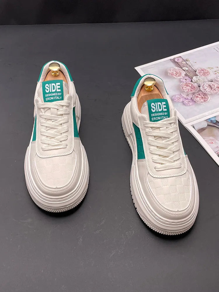 A pair of white green and white black unisex cloth sports casual shoes with a rubber foam sole.