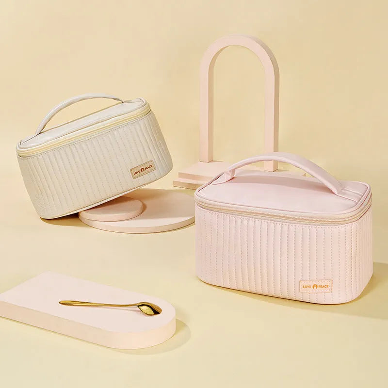 Open-top cake style makeup bag in PU leather showing solid colour options including pink and beige.