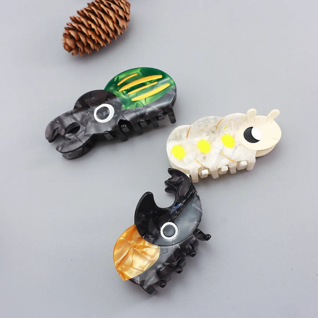 Handmade cellulose acetate beetle hair grip with cartoon caterpillar design in green, orange, or white colour options