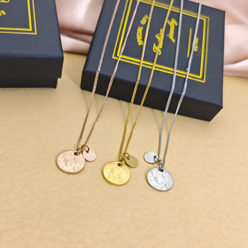 Round coin pendant necklace in gold finish on white background, adjustable 41-50cm stainless steel side chain