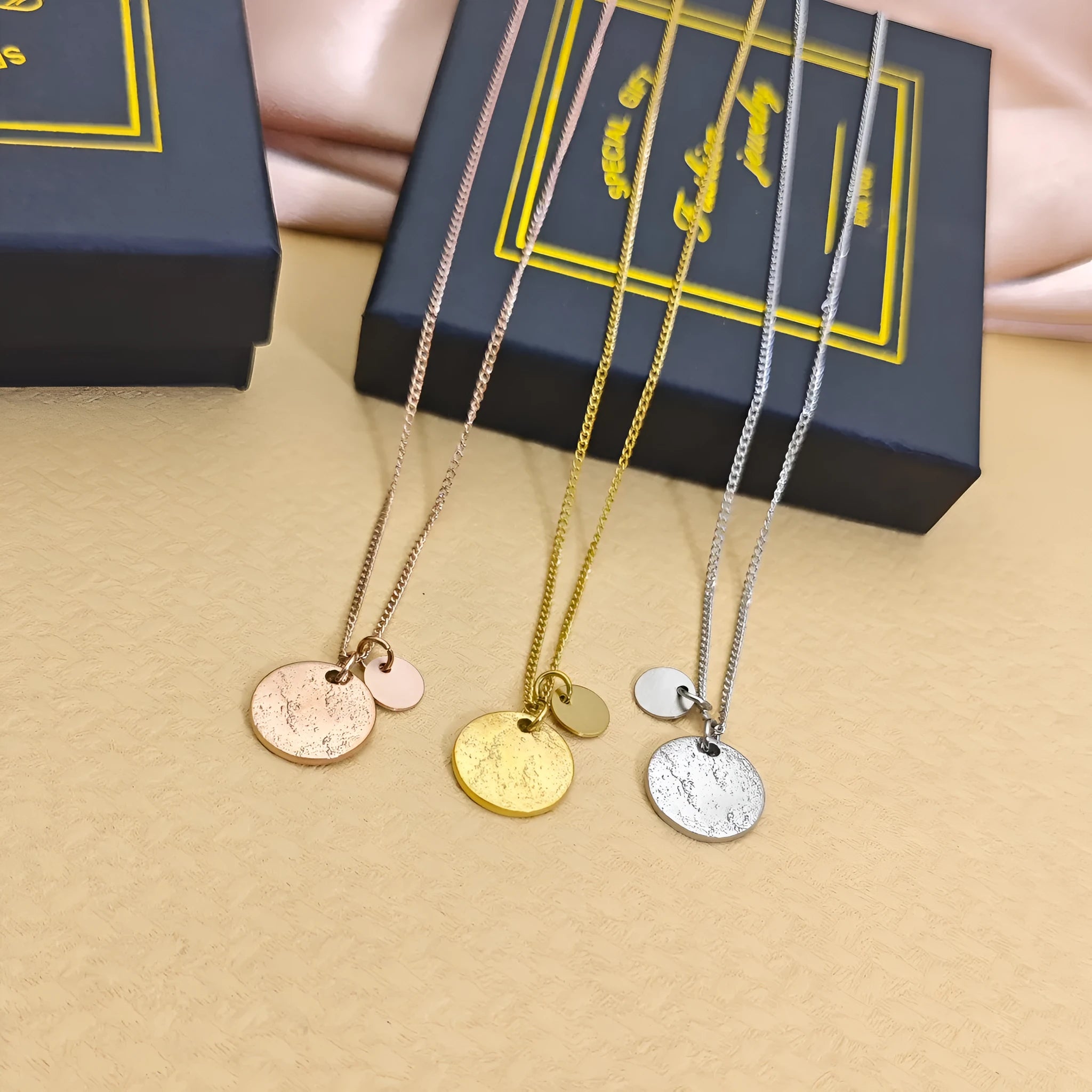 Round coin pendant necklace in gold finish on white background, adjustable 41-50cm stainless steel side chain