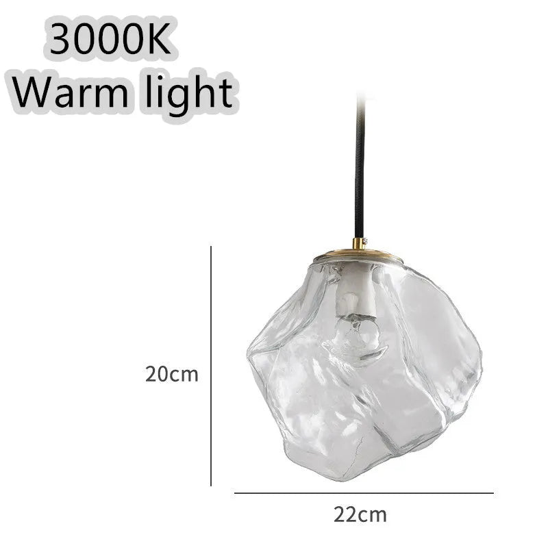 Minimalist ice cube glass chandelier with warm 4000K light, smoky grey shade and black hanging wire over a dining table