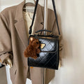 Mini PU backpack in brown with polyester lining, phone pocket, stitching detail, and optional pendant