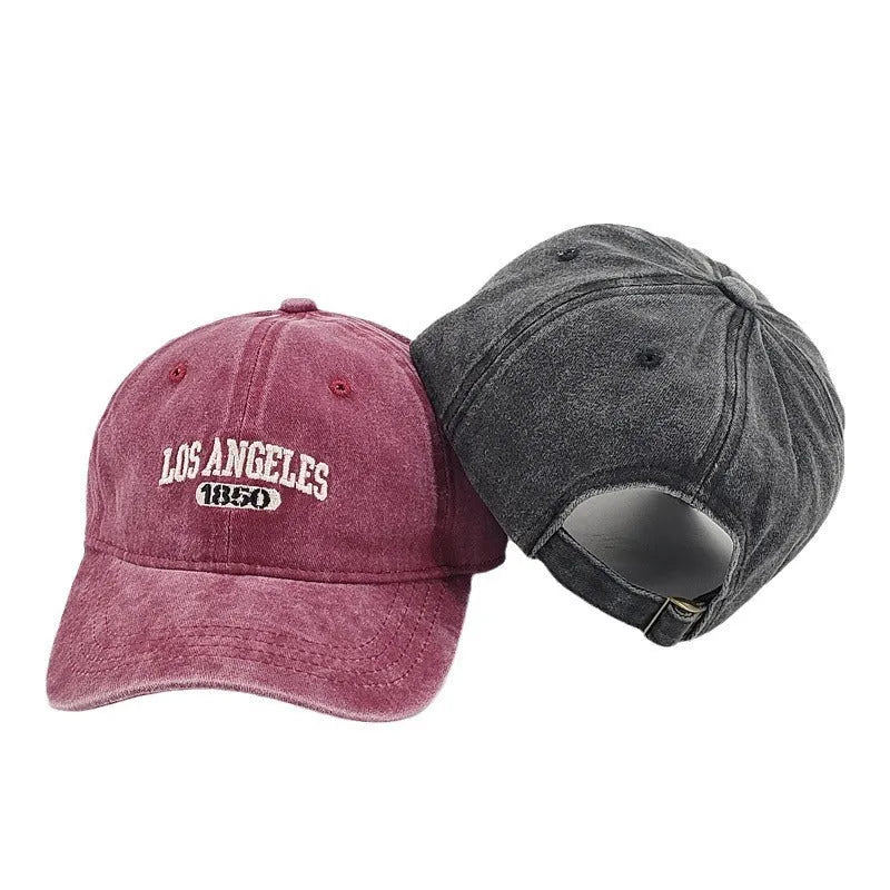 Retro-style personalised embroidered peaked cap with adjustable strap on distressed beige fabric.