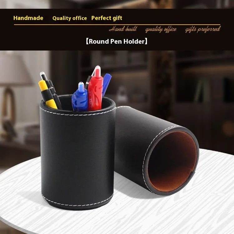 Small round black leather pen holder on a desk