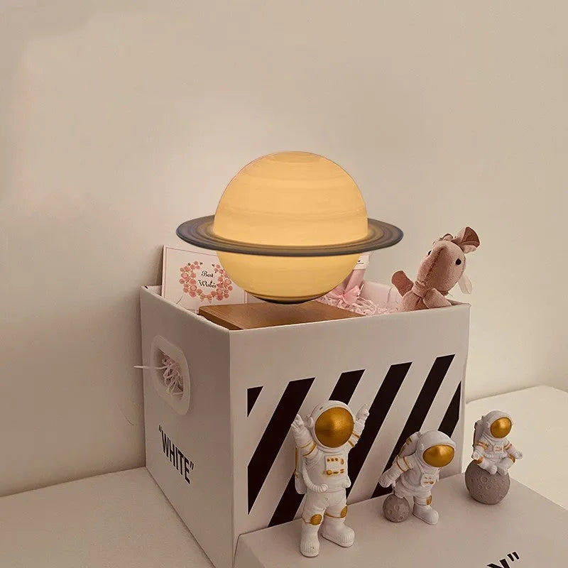 Maglev moon and planet night light floating above base with three astronaut figurines