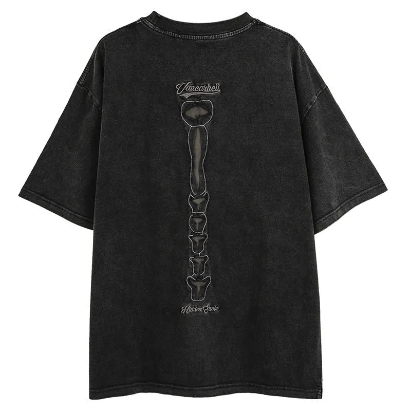 Man's brown loose-fit T-shirt with a skull and letter graphic print on the front, featuring drop-shoulder sleeves.