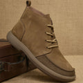 Men's grey genuine leather Martin boots with lace-up front and wedge heel on a textured background.
