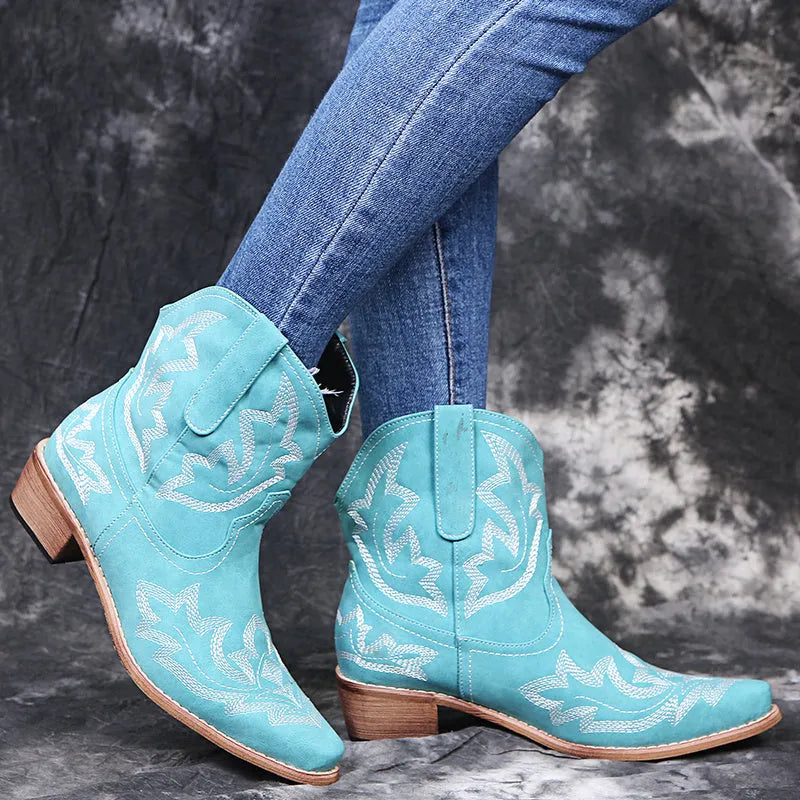 Women's blue embroidered Western ankle boots with a low wedge heel and pointed toe
