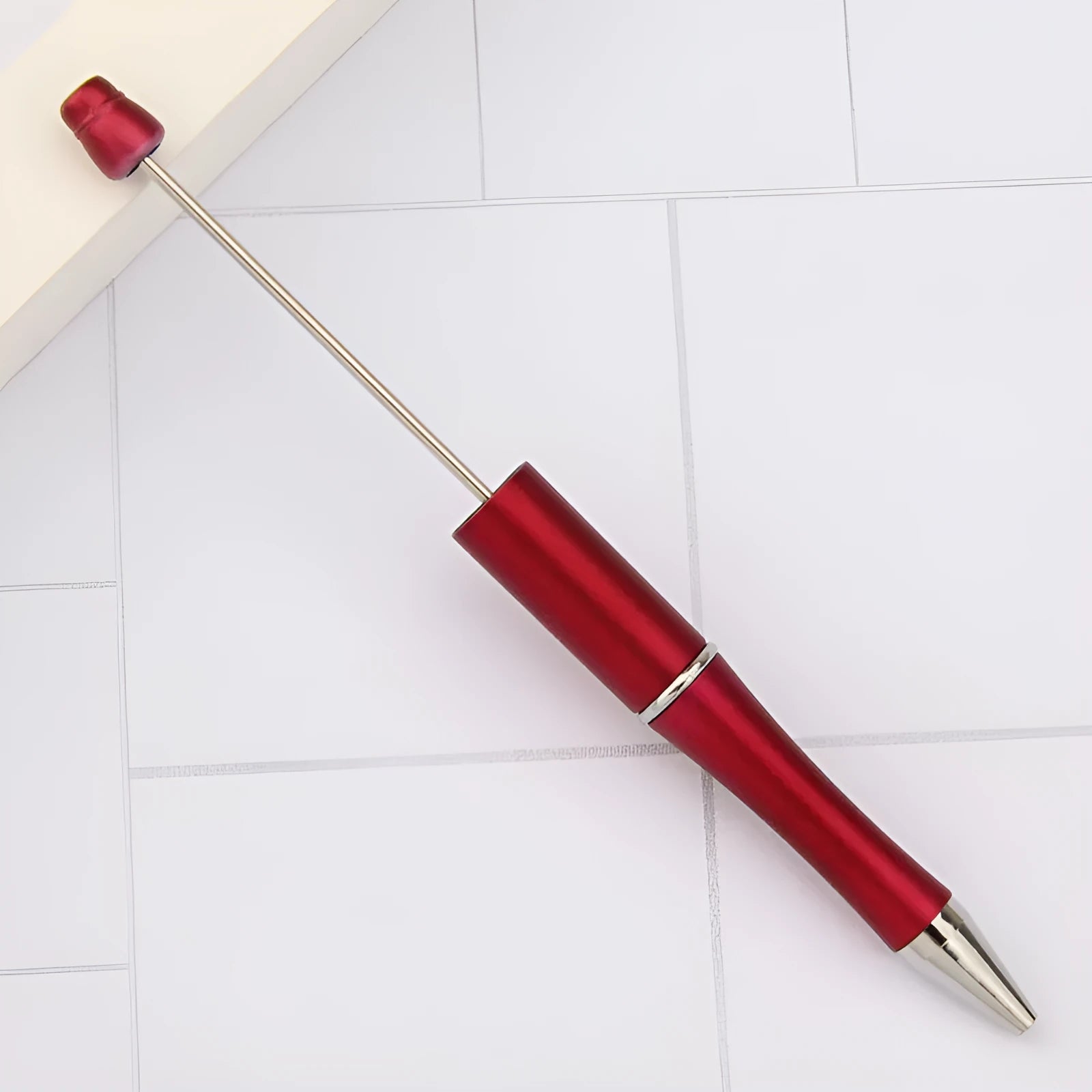 Colourful spinning ballpoint pen with plastic beads on a white background.
