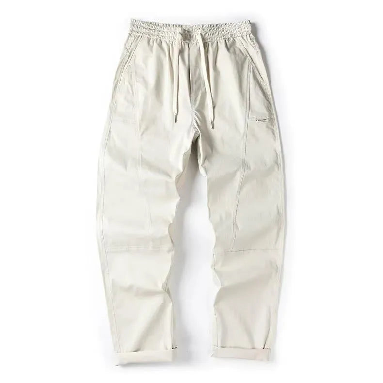 Casual wide-leg cotton trousers in milky white on a model, showing the relaxed fit and trousers-mouth silhouette.