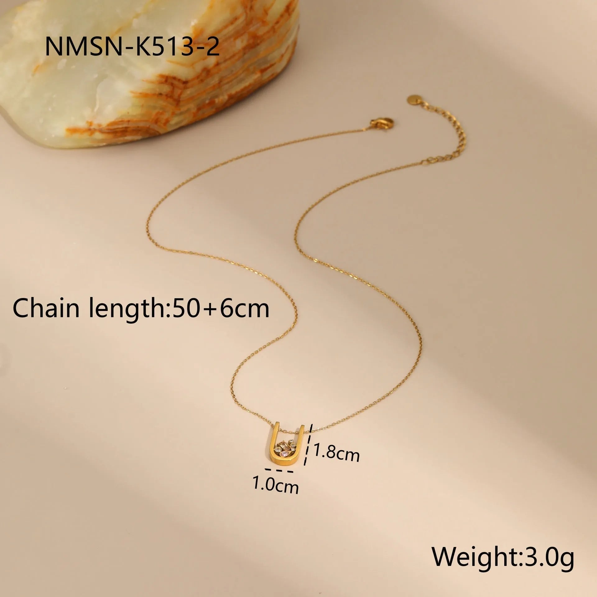 Geometric gold-plated jewellery set with colour zircon stones, showing necklace, ring, and earrings.
