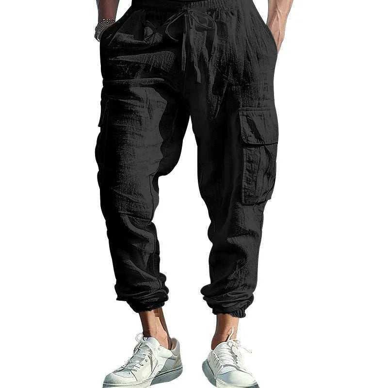 Men's solid colour linen trousers with ankle-tied cuffs, drawstring waist, and multiple pockets.