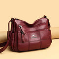 Real leather large capacity crossbody bag with cowhide outer and polyester lining, shown in purple.