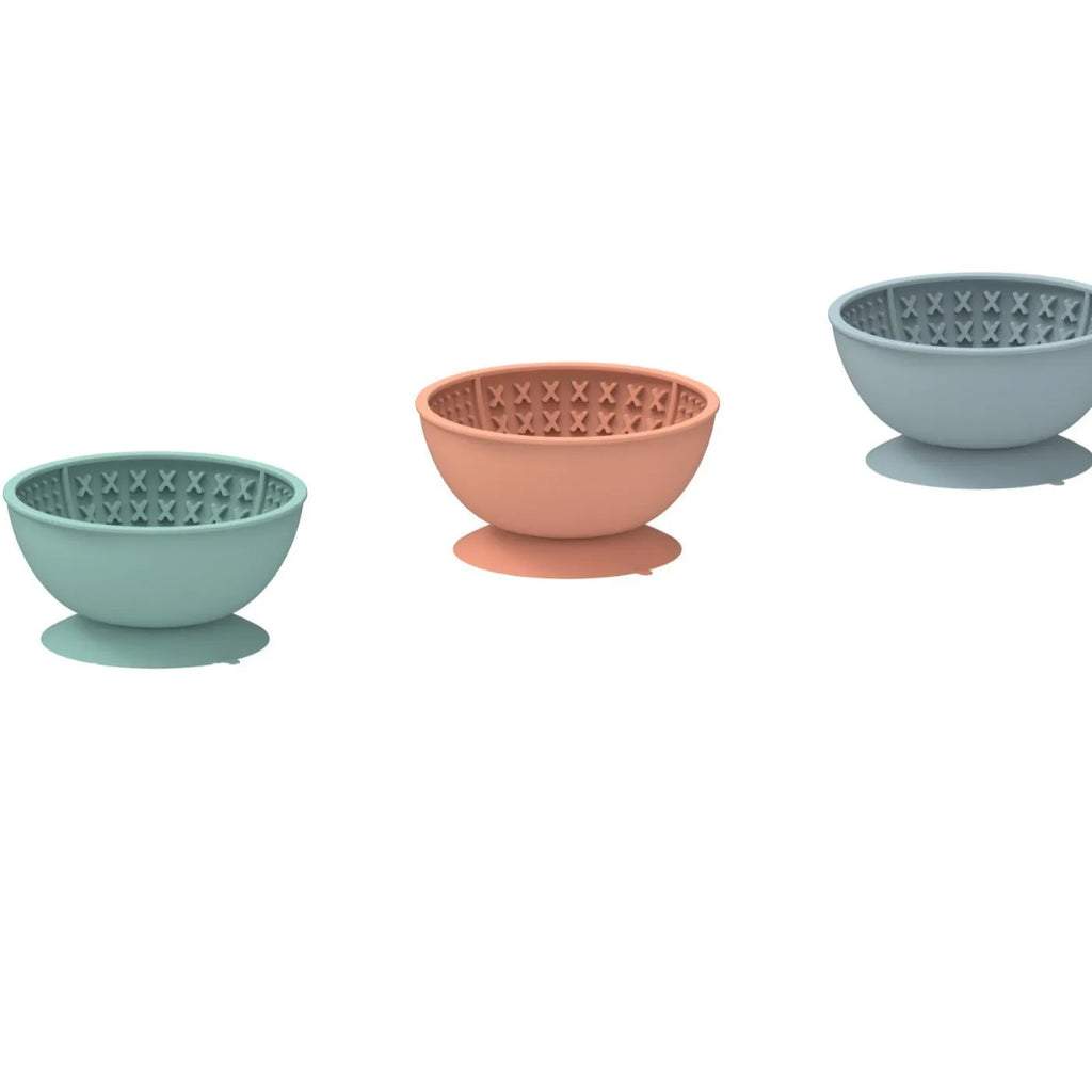 Cyan silicone dog slow feeder bowl with suction cup base and textured feeding surface.