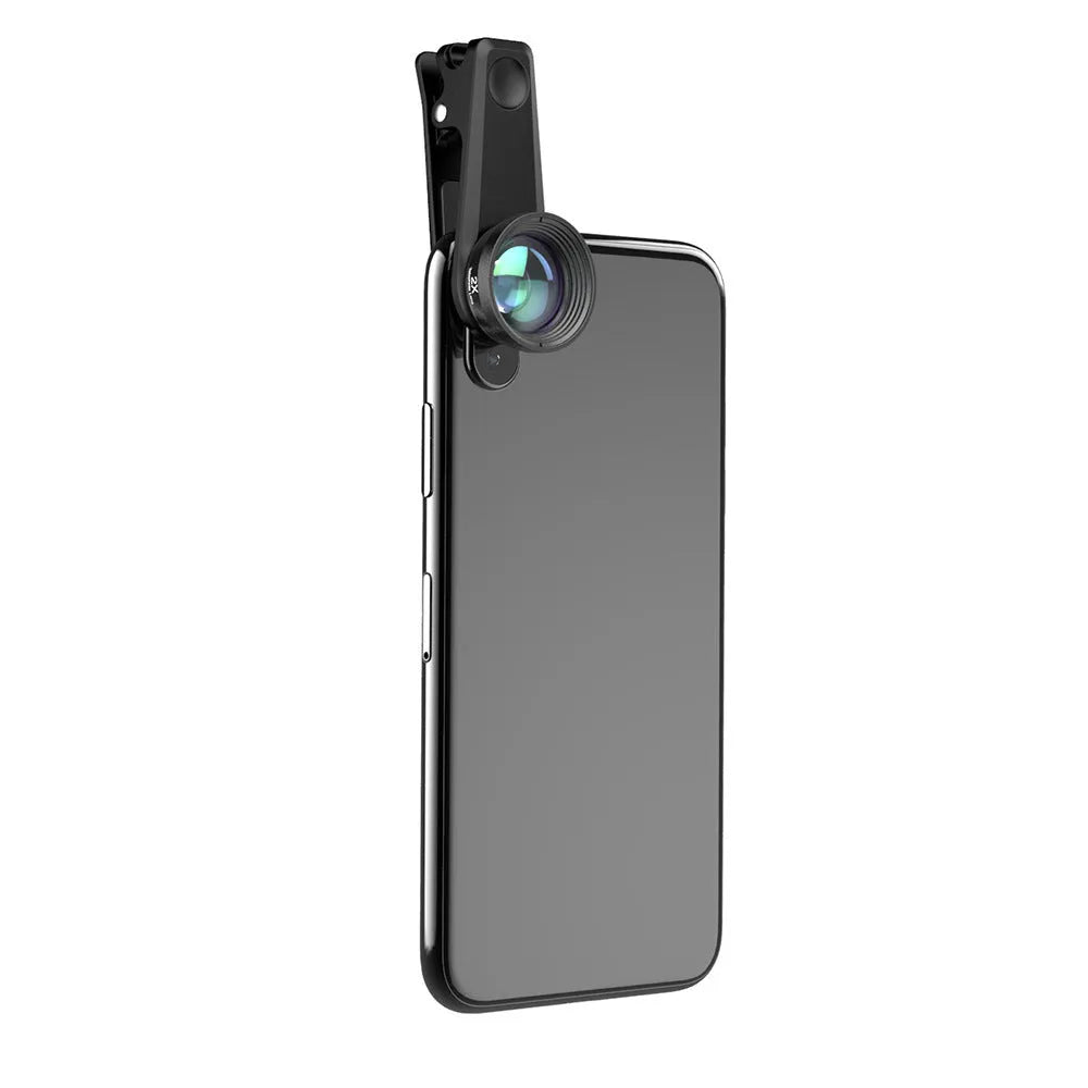 Black 6-in-1 smartphone lens kit with fisheye, macro, telephoto, CPL, and star filters next to a phone on a table.