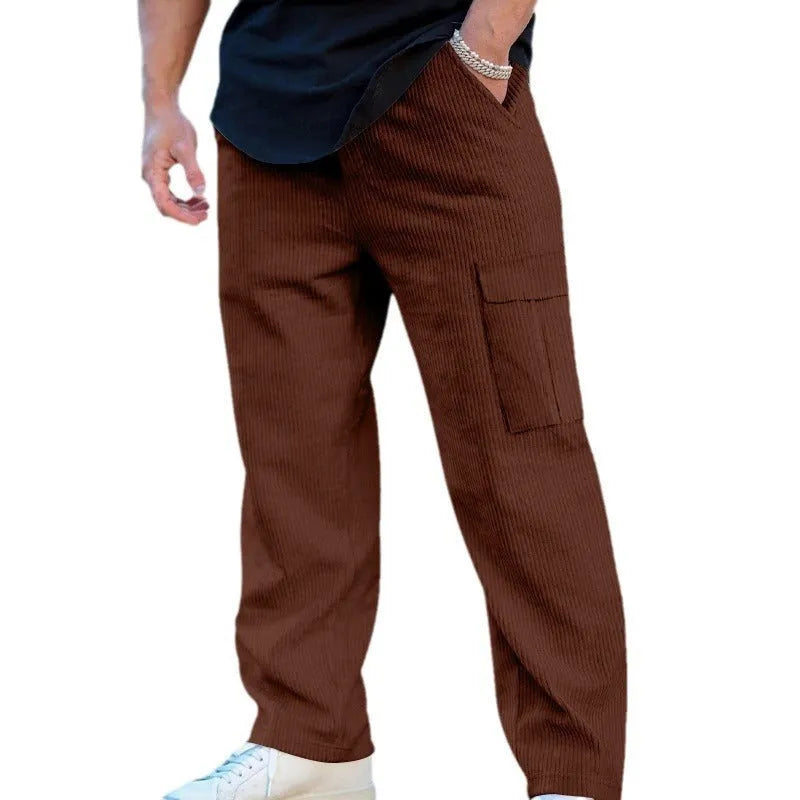 Men's straight-leg corduroy trousers in navy blue, showing loose fit and drawstring waist detail.