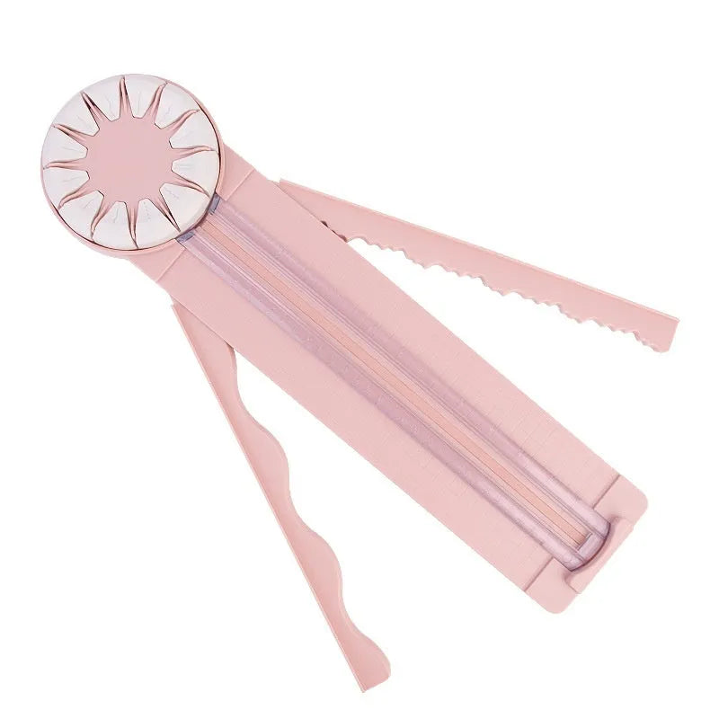 Pink plastic desktop paper cutting machine with a rotary blade for 12 different decorative edge patterns.