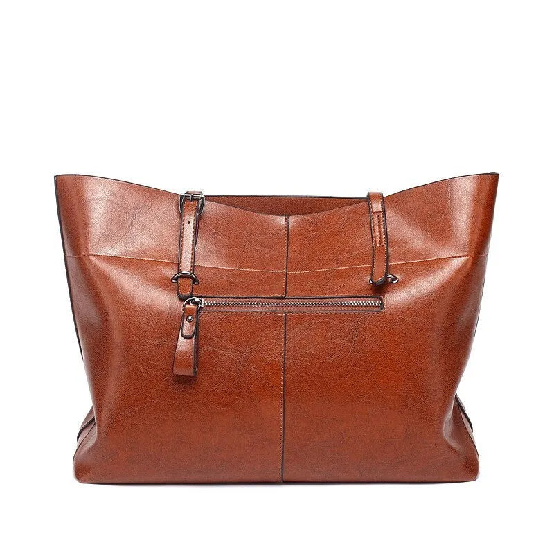 Brown waxed cowhide leather crossbody handbag showing front view with two compartments.