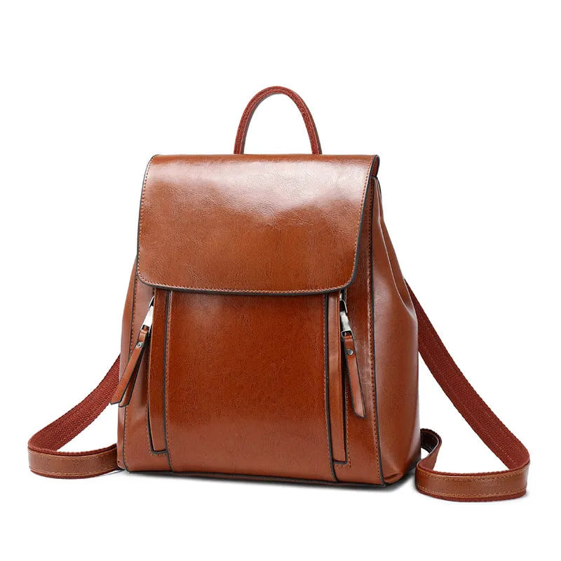Genuine oil-waxed cowhide leather women's backpack in black, showing soft straps, cover flap, and clean stitching.