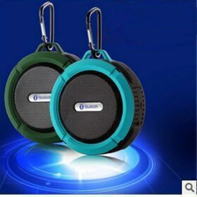 Compact waterproof Bluetooth speaker with a mounting strap in black, blue, green, red, or yellow.