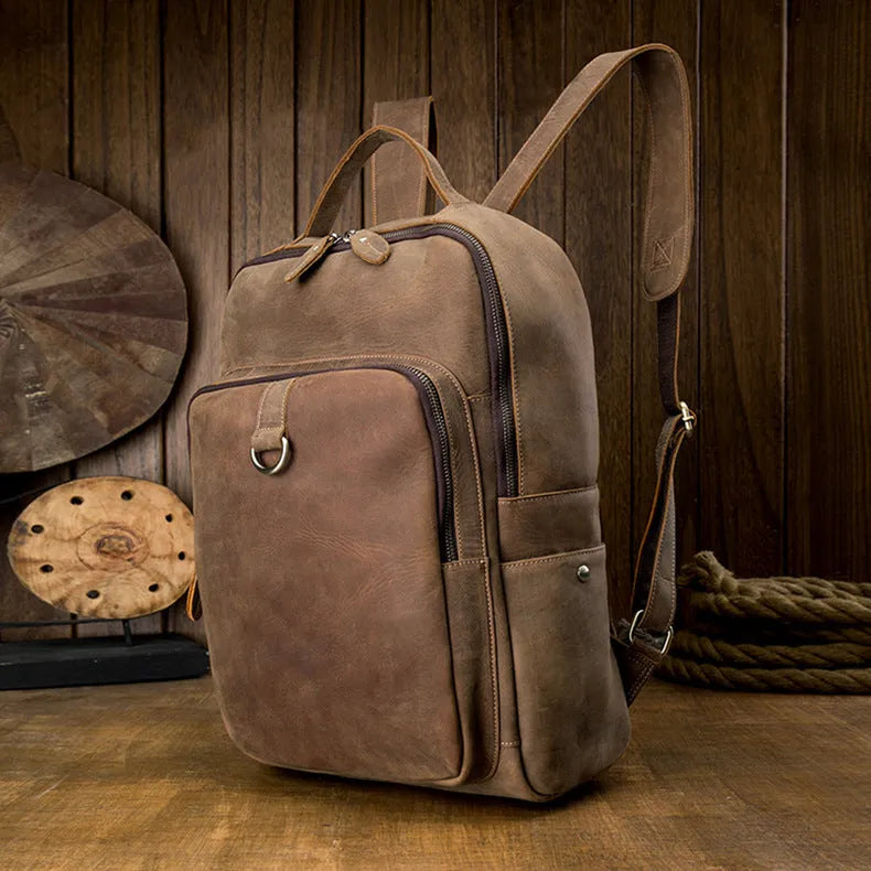 Retro brown leather backpack for men, 20L bucket shape with zipper, laptop pocket and phone pouch.