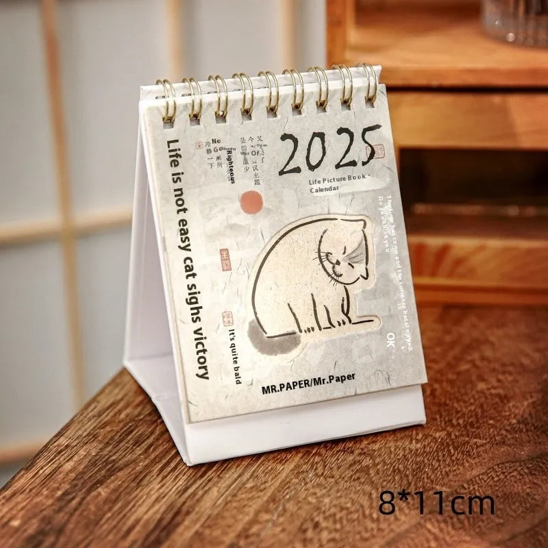 Mini coffee desk calendar 2025 with four design options on small desk surface