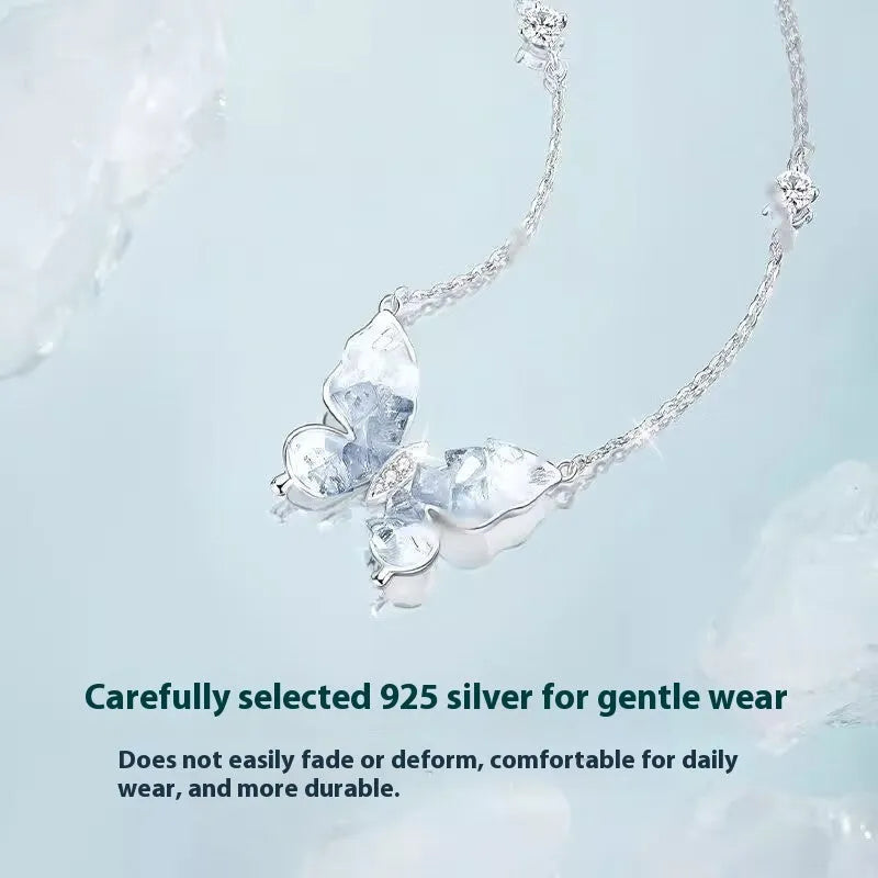 Close-up of a silver butterfly pendant on an adjustable O-ring chain, showing detailed wings and a 41-50 cm length.